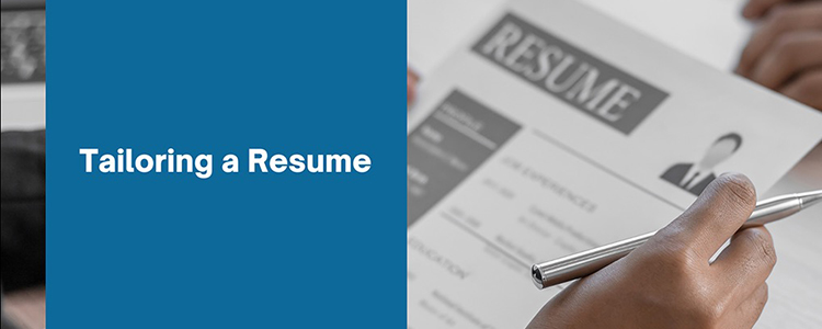a hand holding a pen and document titled resume